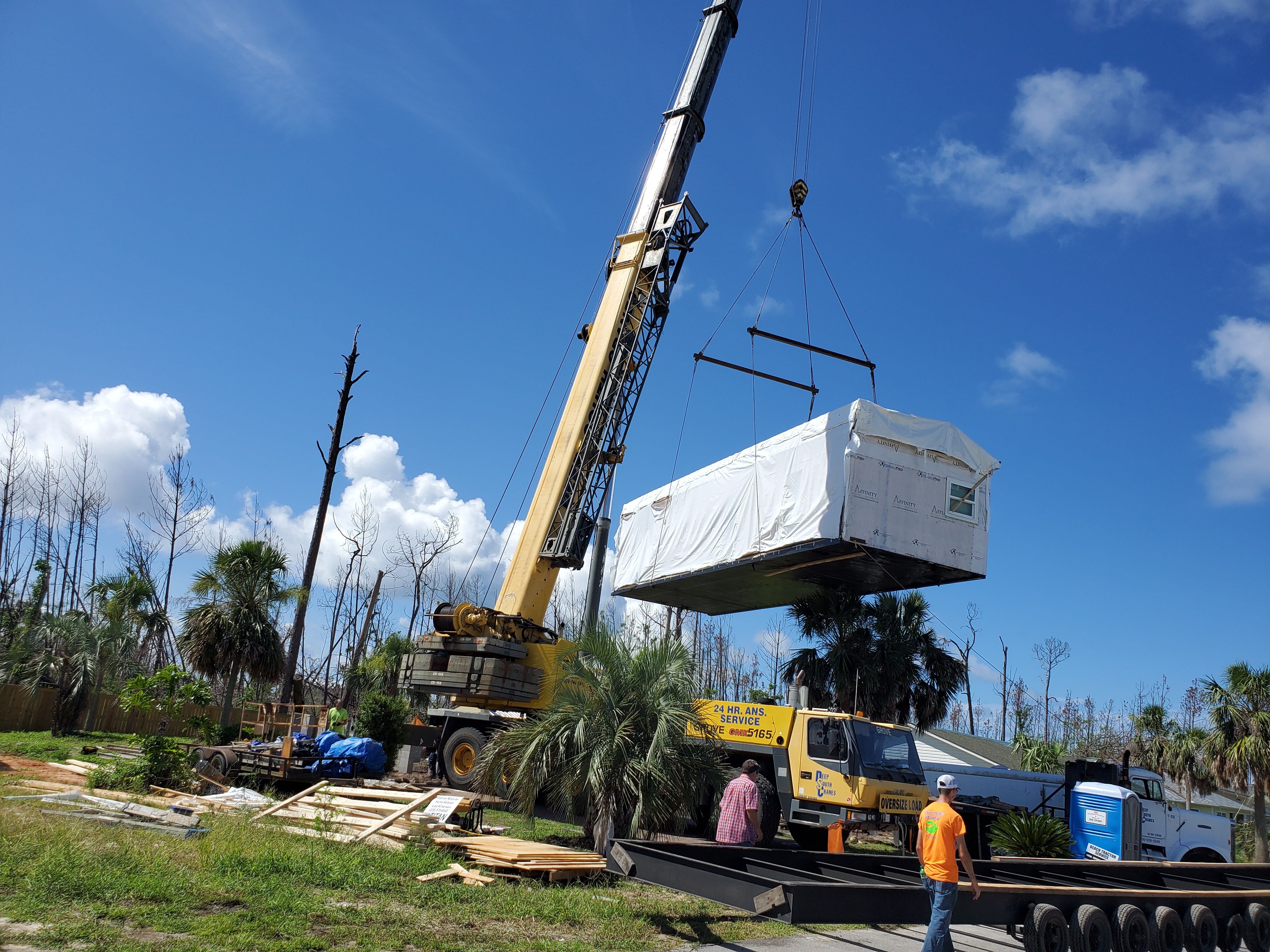 modular home being set with crane